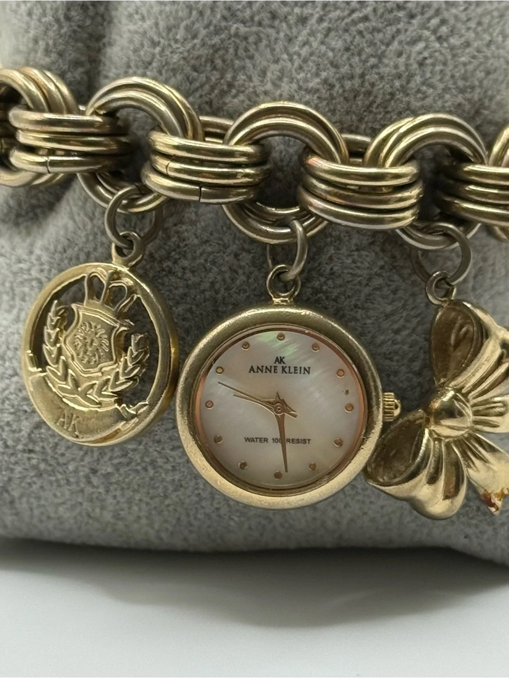 Anne Klein Gold Charm Bracelet Watch with Mother-of-Pearl Dial & Bow Charm